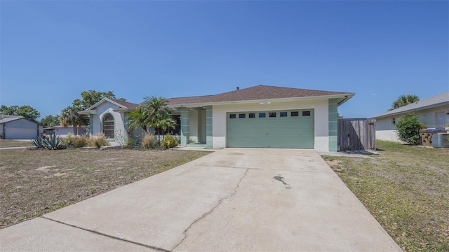 ranch-style house with an attached garage, a front lawn, driveway, and stucco siding