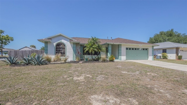single story home with a garage, a front yard, driveway, and stucco siding