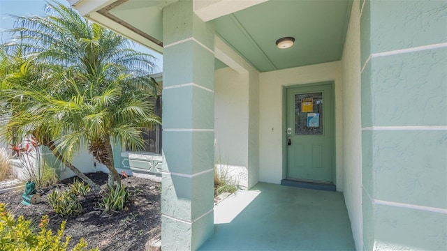 entrance to property featuring stucco siding