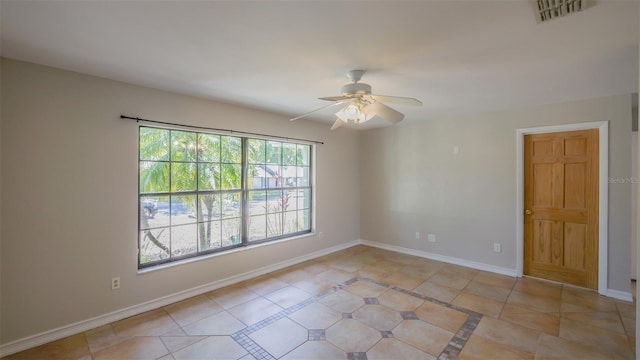 spare room featuring ceiling fan, baseboards, visible vents, and light tile patterned floors