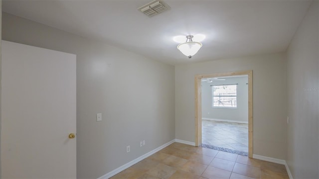 spare room with visible vents, baseboards, and light tile patterned floors