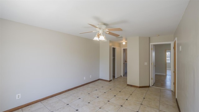 unfurnished room featuring ceiling fan, baseboards, and visible vents