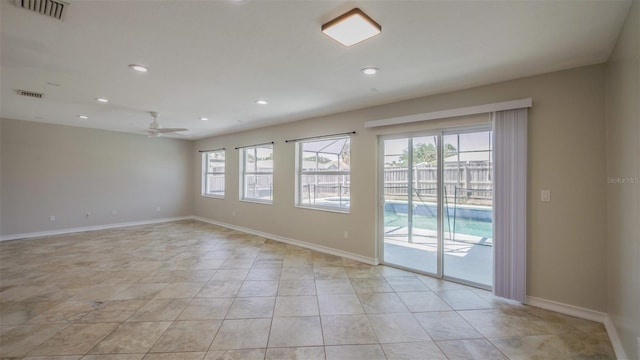 empty room with light tile patterned floors, ceiling fan, visible vents, recessed lighting, and baseboards