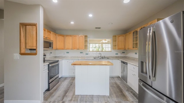 kitchen with open shelves, a center island, appliances with stainless steel finishes, a sink, and wood counters
