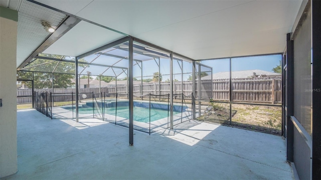 view of pool with a patio, a fenced backyard, and a lanai