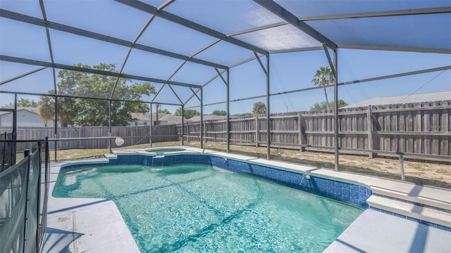 view of pool featuring a pool with connected hot tub, a fenced backyard, glass enclosure, and a patio area