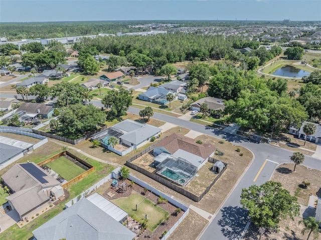 birds eye view of property with a water view and a residential view