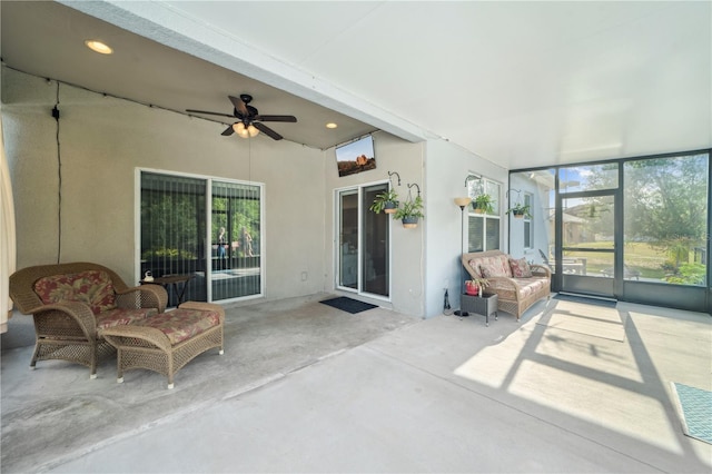 sunroom / solarium with a ceiling fan