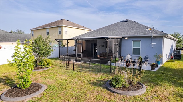 rear view of house with a fenced backyard, stucco siding, a sunroom, a patio area, and a yard