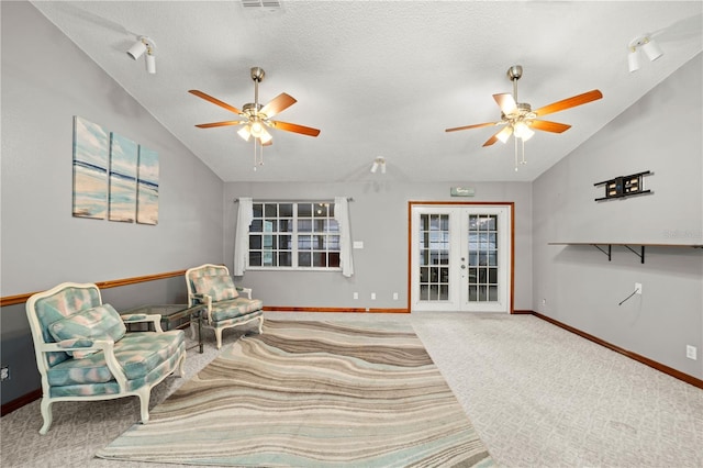 living area featuring french doors, vaulted ceiling, baseboards, carpet, and ceiling fan