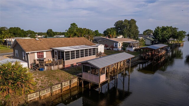 view of dock featuring a deck with water view and a residential view
