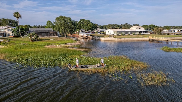 property view of water with a residential view and a dock