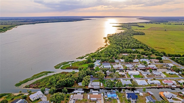 aerial view at dusk featuring a water view