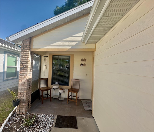 view of exterior entry featuring a porch