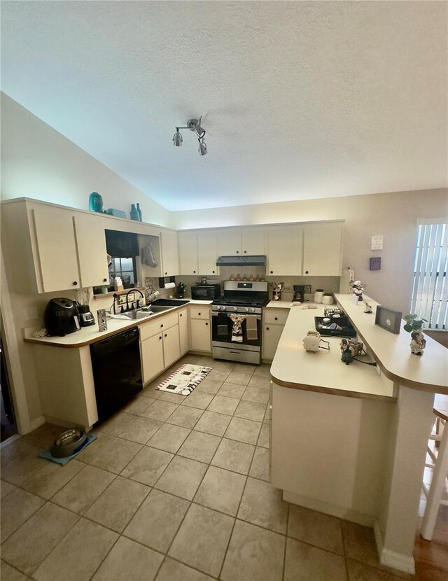 kitchen with a peninsula, light tile patterned floors, light countertops, black appliances, and a sink