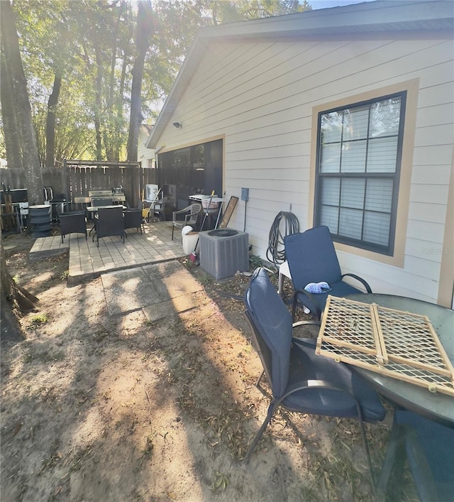 view of patio / terrace featuring outdoor lounge area, fence, and central AC
