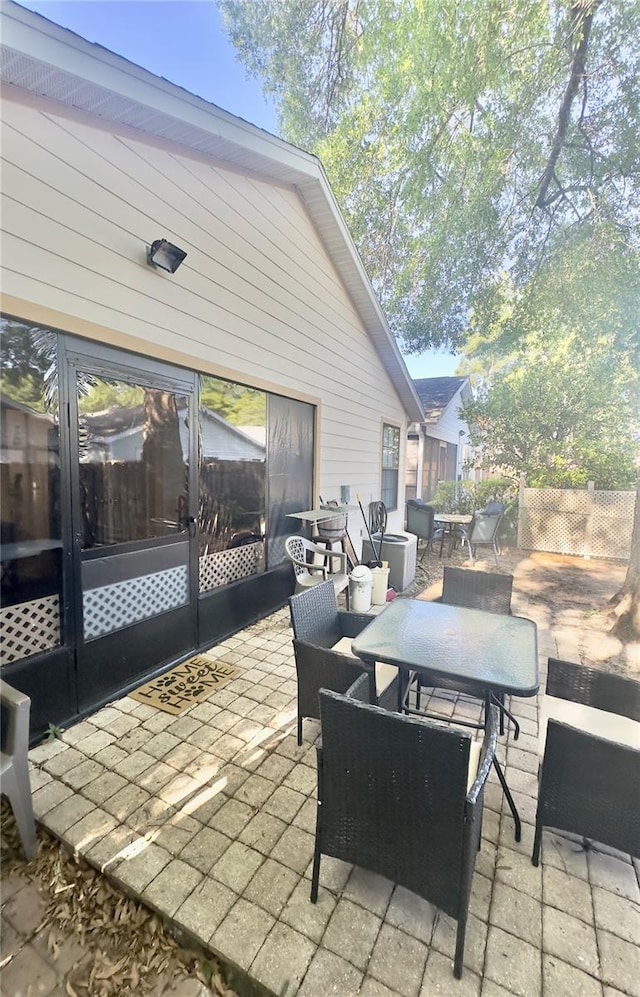 view of patio featuring outdoor dining area and fence