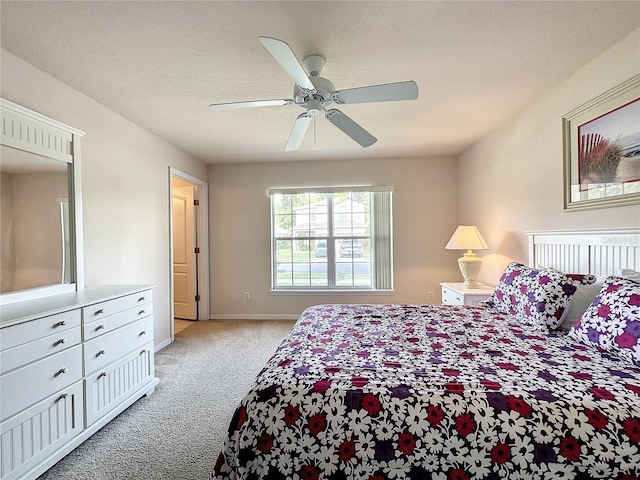 bedroom featuring a ceiling fan, baseboards, and light colored carpet
