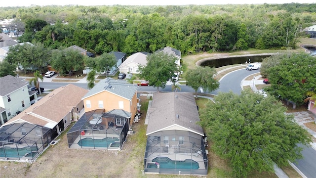 birds eye view of property with a forest view and a residential view