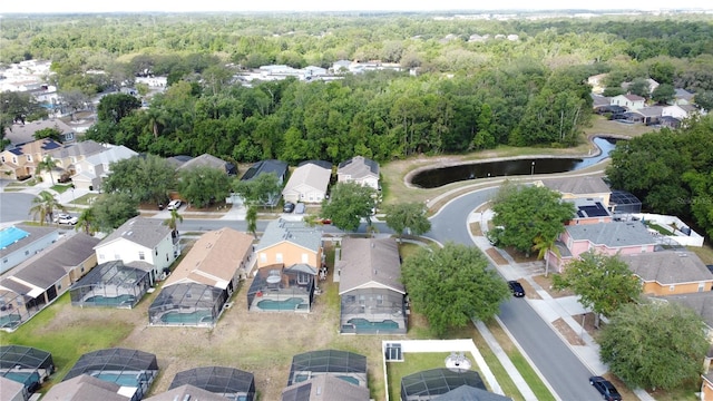 aerial view featuring a view of trees, a residential view, and a water view