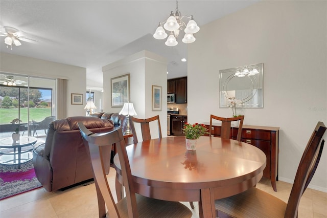 265 Del Sol Ave, Davenport, FL 33837 - dining area with a ceiling fan, a chandelier, and light tile patterned floors