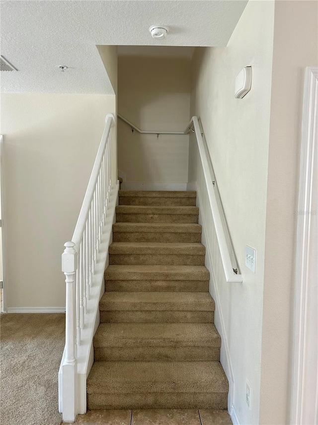 2305 Chatham Place Dr, Orlando, FL 32824 - staircase featuring carpet floors, baseboards, and a textured ceiling