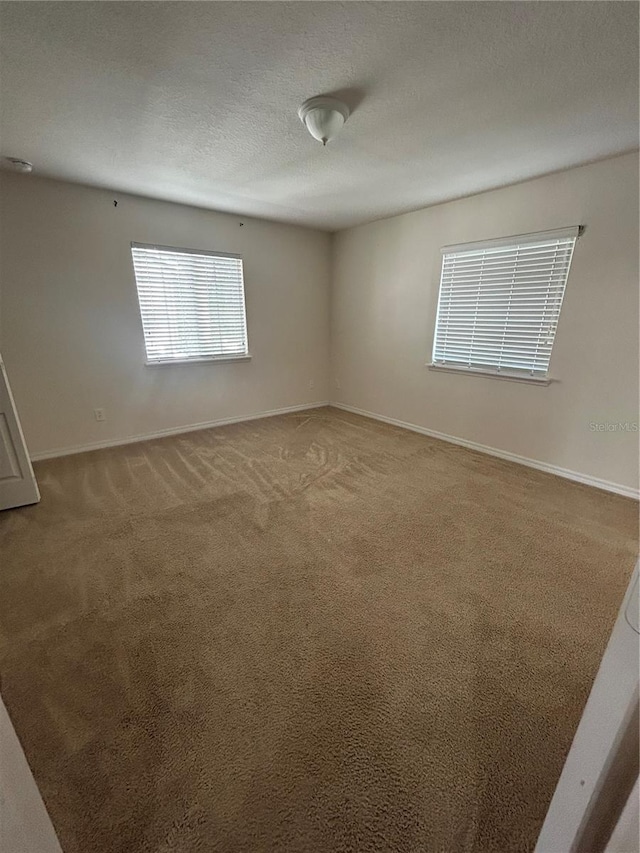 2305 Chatham Place Dr, Orlando, FL 32824 - carpeted spare room with baseboards and a textured ceiling