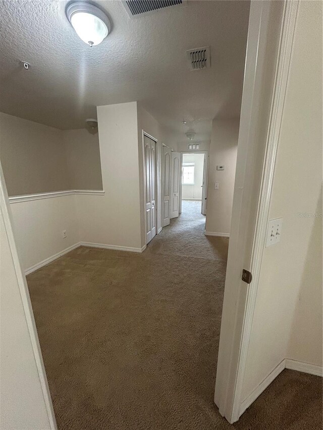 2305 Chatham Place Dr, Orlando, FL 32824 - corridor featuring carpet floors, baseboards, and a textured ceiling