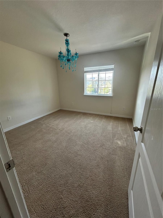2305 Chatham Place Dr, Orlando, FL 32824 - carpeted empty room with a chandelier, baseboards, and a textured ceiling