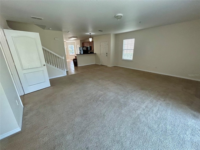 2305 Chatham Place Dr, Orlando, FL 32824 - unfurnished living room with plenty of natural light, light carpet, stairs, and baseboards