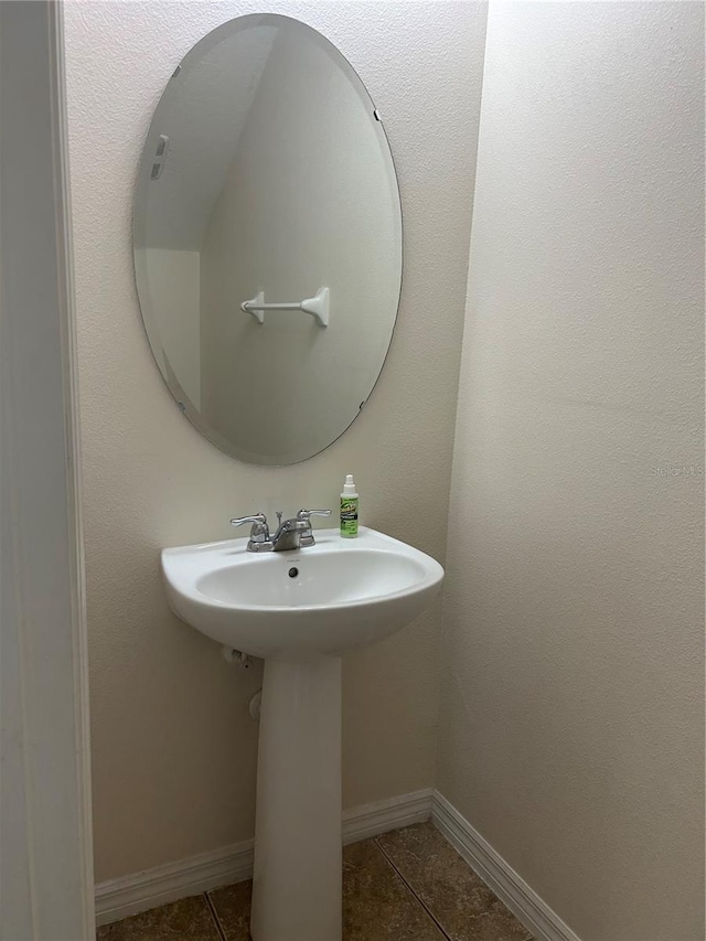 2305 Chatham Place Dr, Orlando, FL 32824 - bathroom featuring tile patterned flooring, baseboards, and a sink