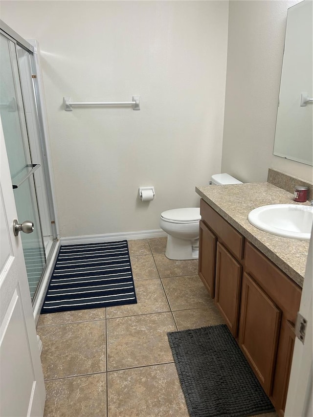 2305 Chatham Place Dr, Orlando, FL 32824 - bathroom with vanity, toilet, a shower stall, tile patterned flooring, and baseboards