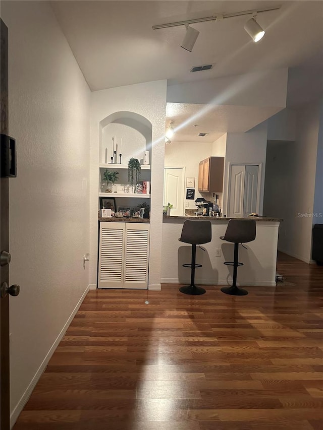 6141 Metrowest Blvd Unit 303, Orlando, FL 32835 - bar featuring rail lighting, dark wood-style floors, and vaulted ceiling