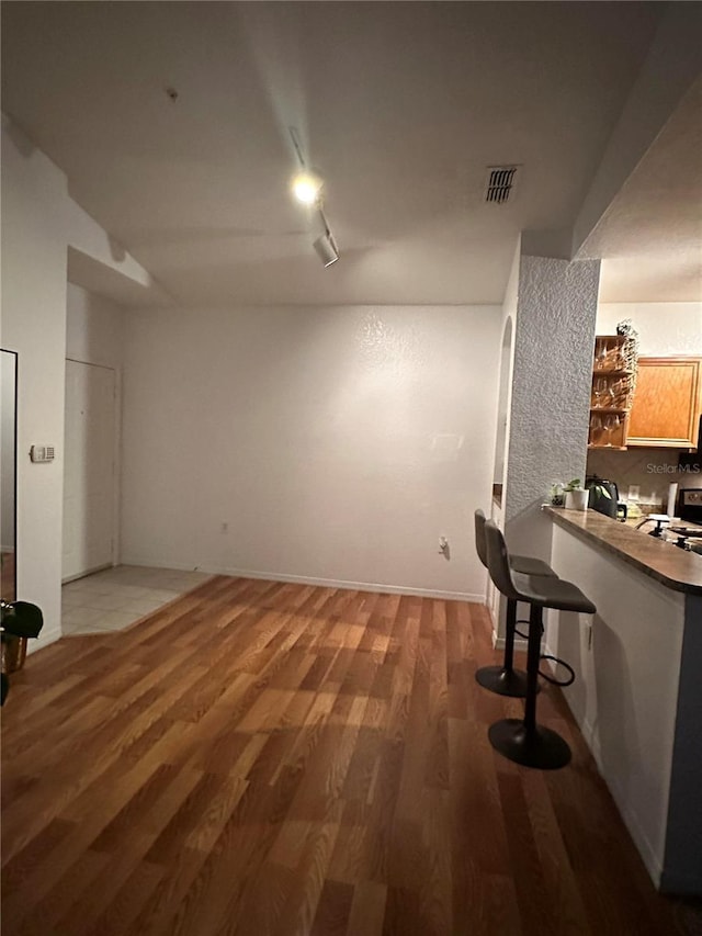 6141 Metrowest Blvd Unit 303, Orlando, FL 32835 - living room featuring light wood-style floors and track lighting