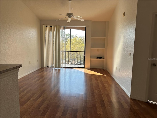 6141 Metrowest Blvd Unit 303, Orlando, FL 32835 - unfurnished dining area featuring a textured wall, wood finished floors, ceiling fan, and built in shelves