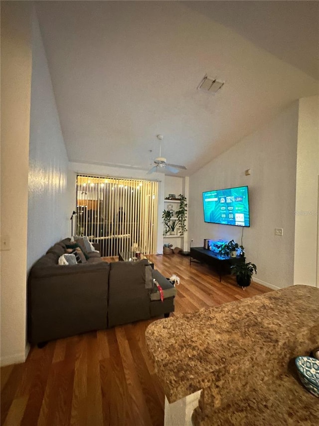 6141 Metrowest Blvd Unit 303, Orlando, FL 32835 - living area featuring vaulted ceiling, wood finished floors, and a ceiling fan