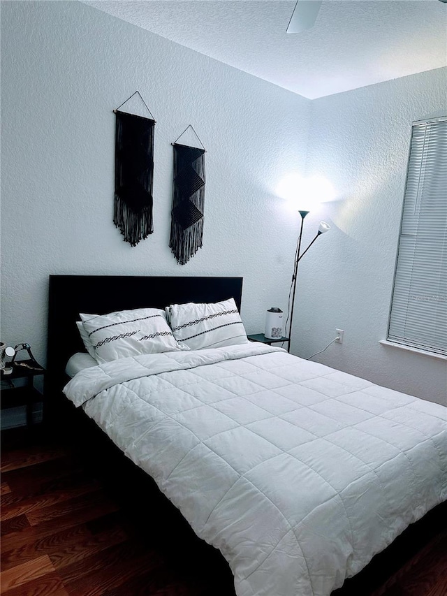 6141 Metrowest Blvd Unit 303, Orlando, FL 32835 - bedroom with wood finished floors and a textured wall