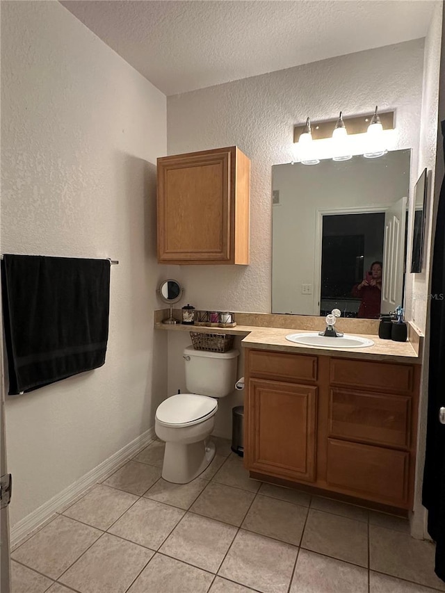 6141 Metrowest Blvd Unit 303, Orlando, FL 32835 - bathroom featuring vanity, a textured ceiling, a textured wall, and tile patterned flooring