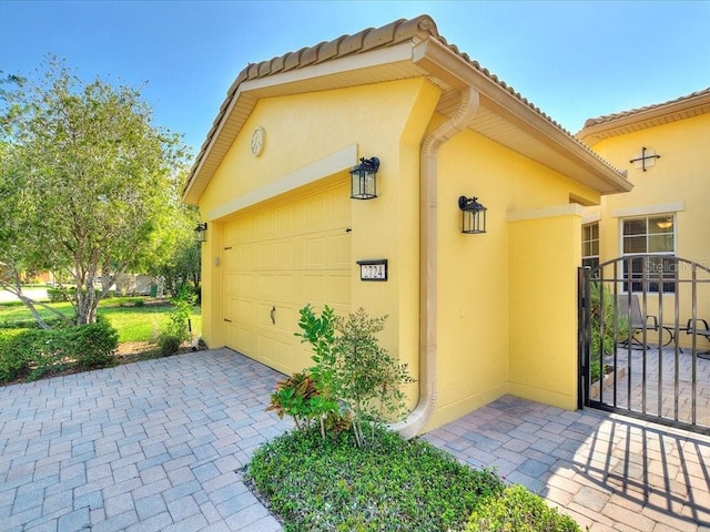 2724 Palm Tree Dr, Poinciana, FL 34759 - view of property exterior with a garage, driveway, and stucco siding