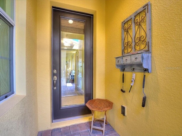 2724 Palm Tree Dr, Poinciana, FL 34759 - view of exterior entry with stucco siding