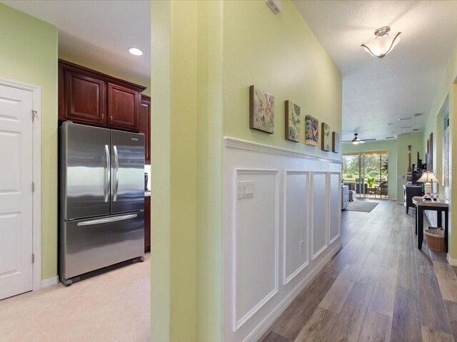 2724 Palm Tree Dr, Poinciana, FL 34759 - corridor featuring a decorative wall, visible vents, and light wood-type flooring