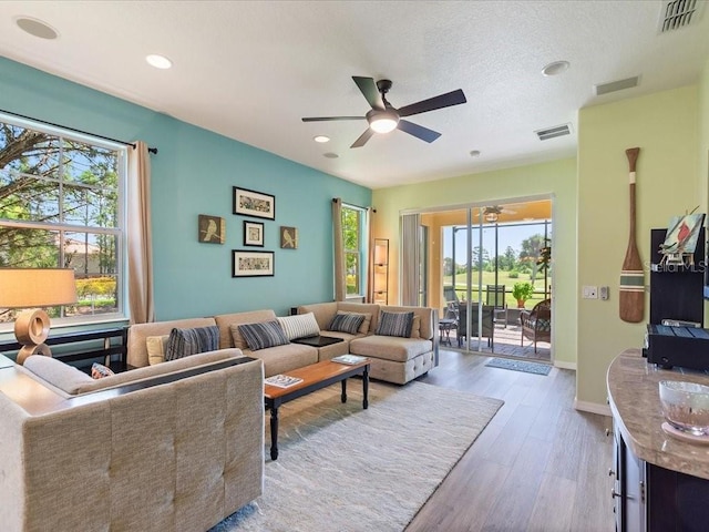 2724 Palm Tree Dr, Poinciana, FL 34759 - living room featuring wood finished floors, a ceiling fan, visible vents, and recessed lighting
