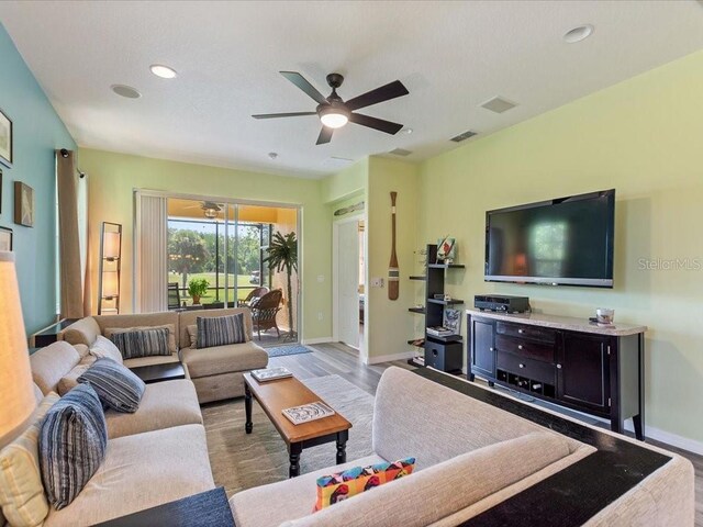 2724 Palm Tree Dr, Poinciana, FL 34759 - living room with wood finished floors, ceiling fan, baseboards, visible vents, and recessed lighting