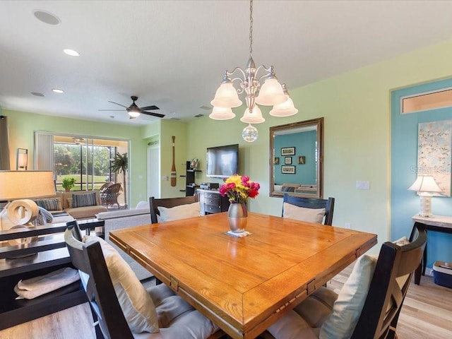 2724 Palm Tree Dr, Poinciana, FL 34759 - dining room featuring recessed lighting, light wood-type flooring, and ceiling fan with notable chandelier