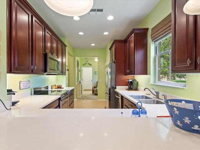 2724 Palm Tree Dr, Poinciana, FL 34759 - kitchen with recessed lighting, a sink, stainless steel appliances, visible vents, and light countertops