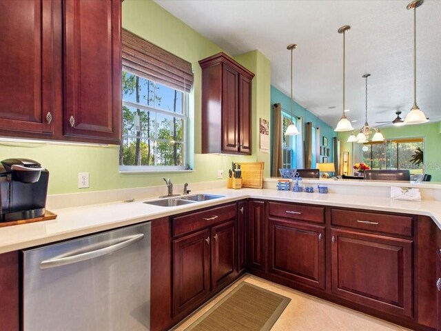 2724 Palm Tree Dr, Poinciana, FL 34759 - kitchen featuring decorative light fixtures, reddish brown cabinets, stainless steel dishwasher, and light countertops