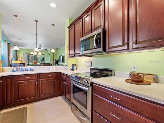 2724 Palm Tree Dr, Poinciana, FL 34759 - kitchen featuring light countertops, light tile patterned flooring, decorative light fixtures, and stainless steel appliances