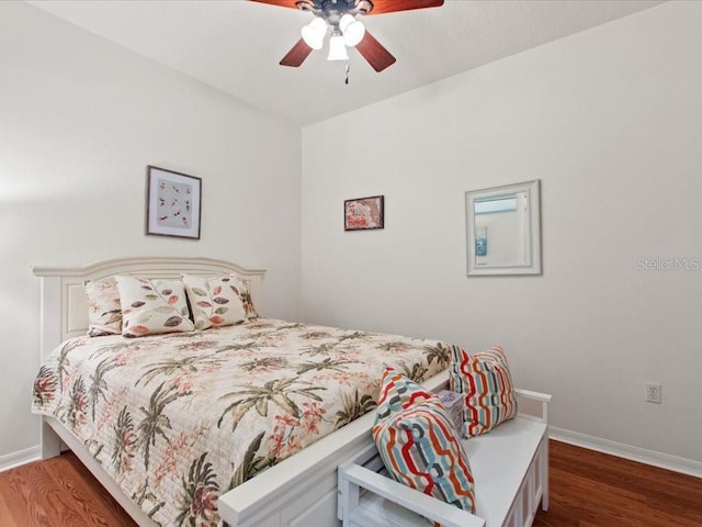2724 Palm Tree Dr, Poinciana, FL 34759 - bedroom featuring baseboards, wood finished floors, and a ceiling fan