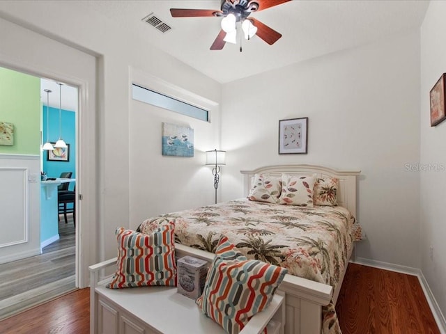 2724 Palm Tree Dr, Poinciana, FL 34759 - bedroom featuring baseboards, a ceiling fan, wood finished floors, and visible vents
