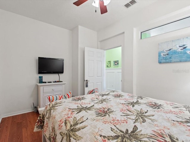 2724 Palm Tree Dr, Poinciana, FL 34759 - bedroom with wood finished floors, visible vents, baseboards, and ceiling fan